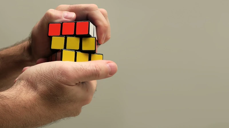 Photo of person working a rubric’s cube